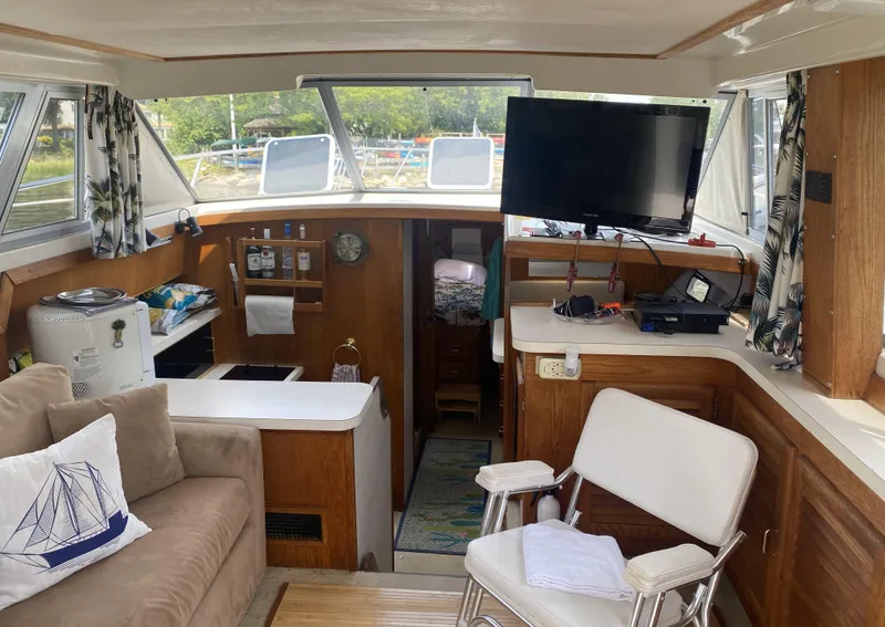 Slide: The Image of Interior of 1987 Silverton 34 Convertible boat with seating, TV, and kitchenette. - 10
