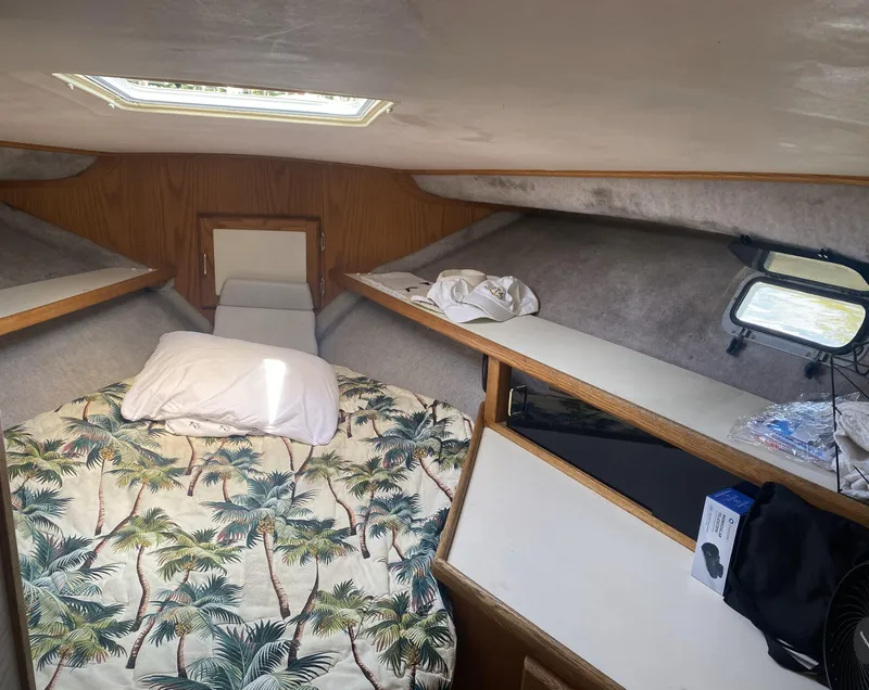 Slide: The Image of Cozy cabin interior of 1987 Silverton 34 Convertible with tropical bedding and skylight. - 13