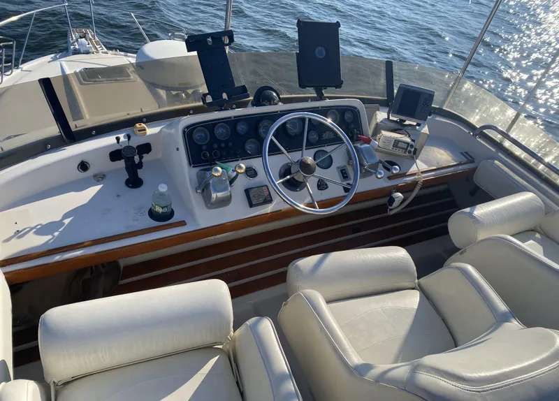 Slide: The Image of 1987 Silverton 34 Convertible boat helm with steering wheel, gauges, and navigation equipment. - 7