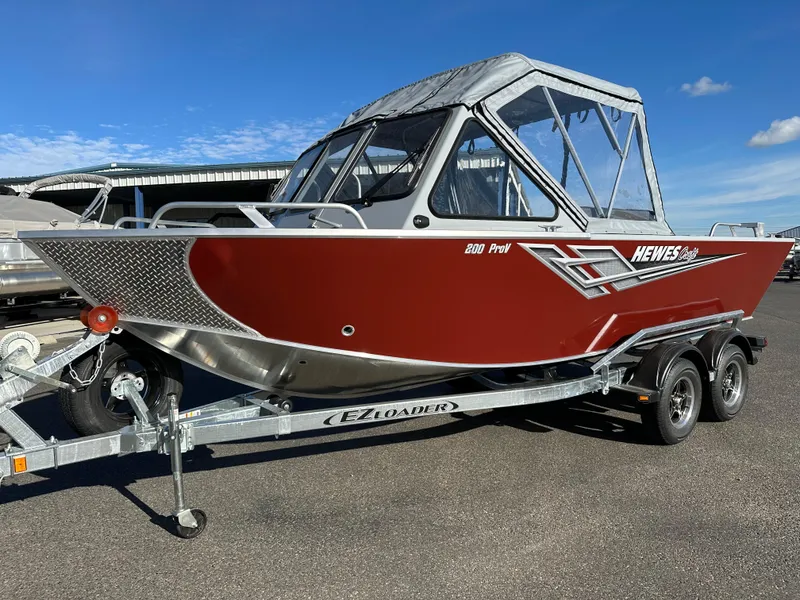 The Image of 2025 Hewescraft 200 ProV boat on trailer, red and silver design. - 0