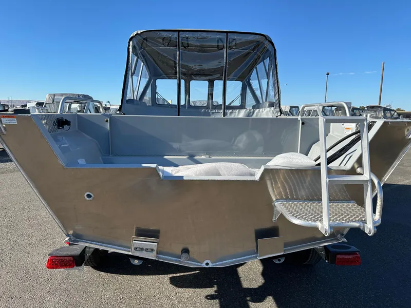 Slide: The Image of 2025 Hewescraft 200 ProV boat, rear view, silver exterior, clear sky background. - 3