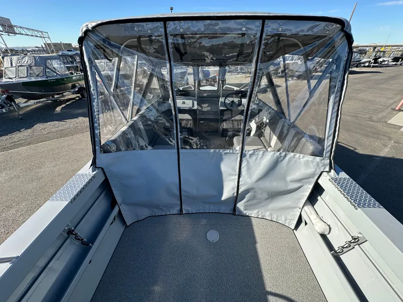 Slide: The Image of 2025 Hewescraft 200 ProV boat with covered cockpit, parked outdoors. - 5