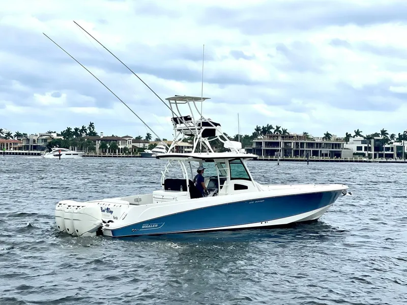 The Image of 2013 Boston Whaler 370 Outrage boat cruising on a scenic waterway. - 0