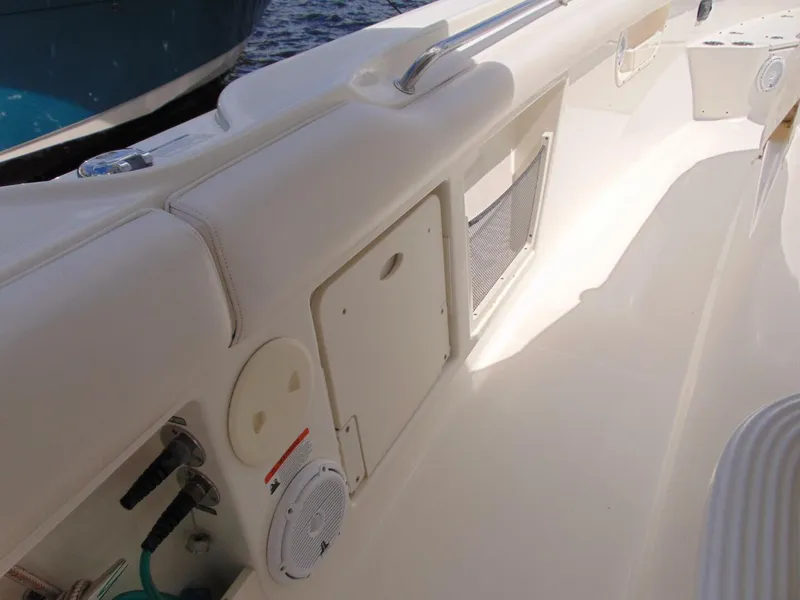 Slide: The Image of 2013 Boston Whaler 370 Outrage boat interior with storage compartments and speaker. - 20