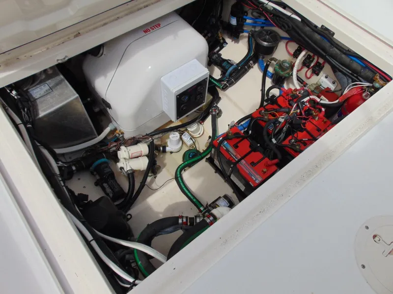 Slide: The Image of Engine compartment of 2013 Boston Whaler 370 Outrage, showcasing mechanical components and wiring. - 28