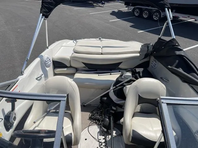 Slide: The Image of 2014 Tahoe Q5i SF boat interior with white seating and steering wheel. - 13