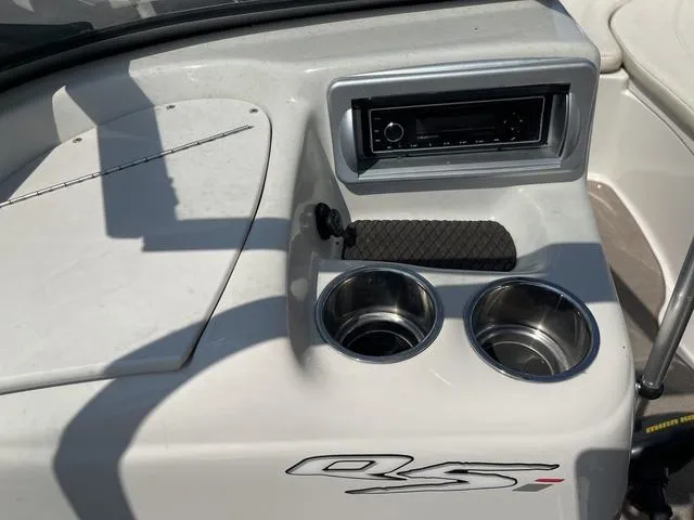 Slide: The Image of 2014 Tahoe Q5i SF boat console with stereo and cup holders. - 14
