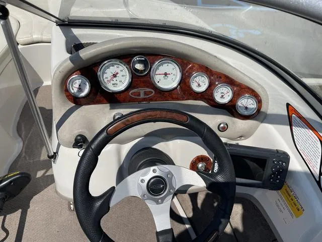 Slide: The Image of 2014 Tahoe Q5i SF boat dashboard with steering wheel and gauges. - 16