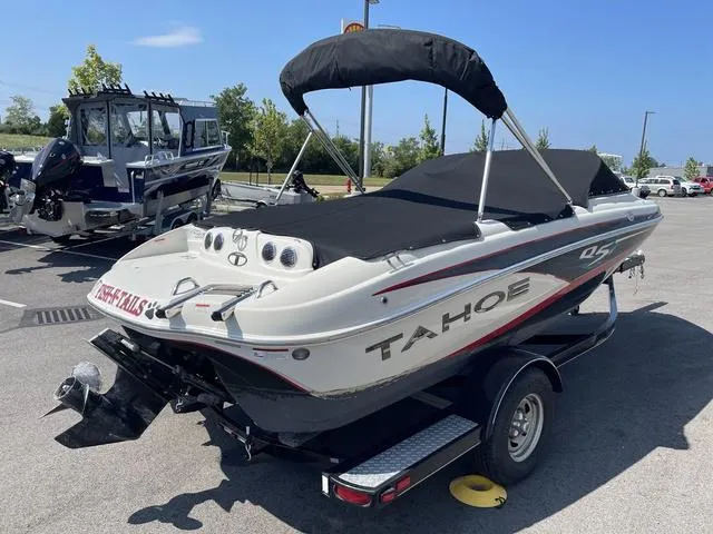 Slide: The Image of 2014 Tahoe Q5i SF boat on trailer, parked outdoors. - 3