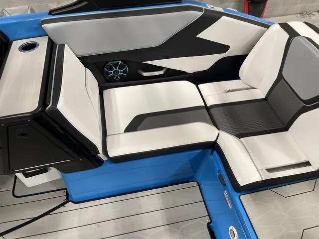 Slide: The Image of 2023 Yamaha Boats 255XD interior with sleek white and black seating, blue accents. - 13