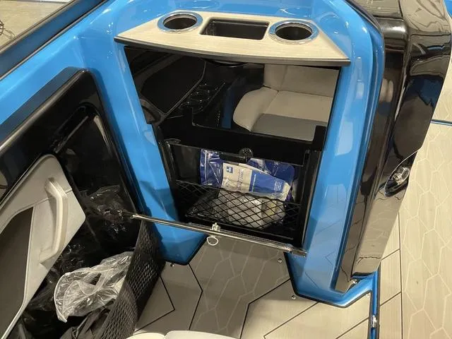 Slide: The Image of 2023 Yamaha Boats 255XD interior with storage compartment and cup holders. - 17