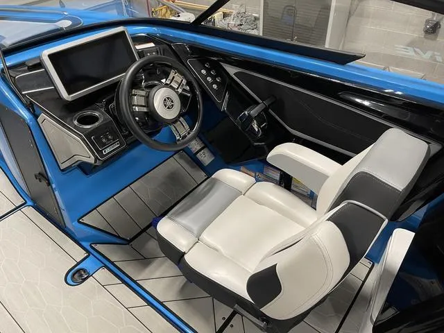 Slide: The Image of 2023 Yamaha Boats 255XD cockpit with modern steering and control panel. - 18