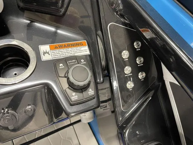 Slide: The Image of Control panel of 2023 Yamaha Boats 255XD with warning label and buttons. - 22