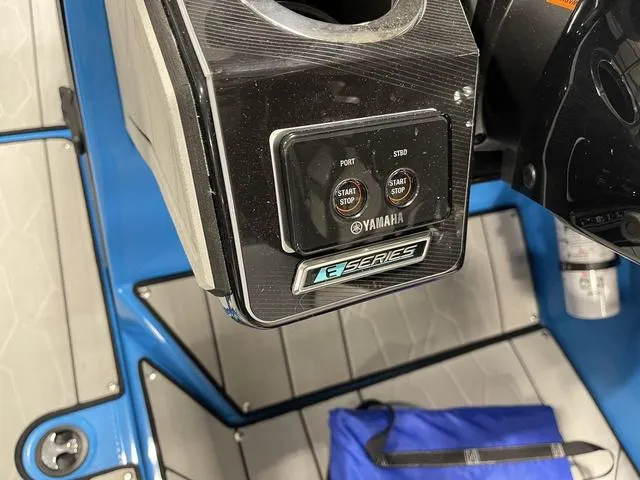 Slide: The Image of Yamaha Boats 255XD 2023 control panel with start/stop buttons and E-Series branding. - 23