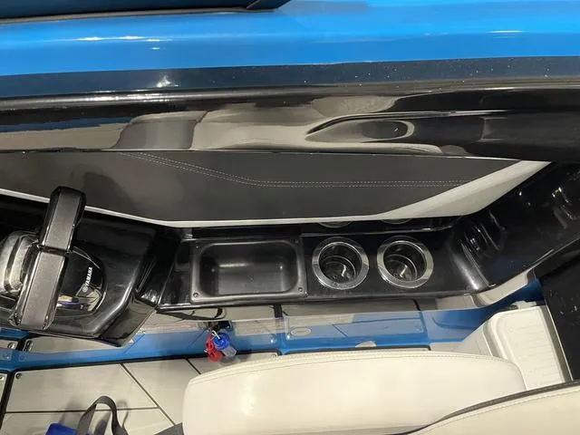 Slide: The Image of Interior of 2023 Yamaha Boats 255XD, featuring sleek design and cup holders. - 24