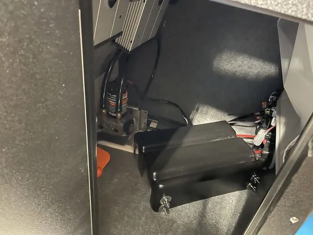 Slide: The Image of Interior compartment of 2023 Yamaha Boats 255XD, showcasing wiring and components. - 26