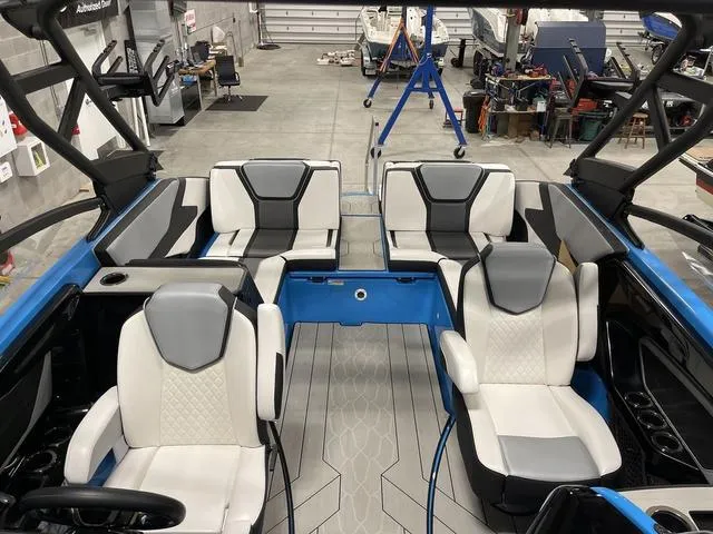 Slide: The Image of Interior of 2023 Yamaha Boats 255XD, featuring modern seating and sleek design in a workshop setting. - 36