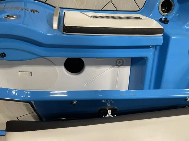 Slide: The Image of 2023 Yamaha Boats 255XD interior detail, featuring blue and white seating and storage compartment. - 42
