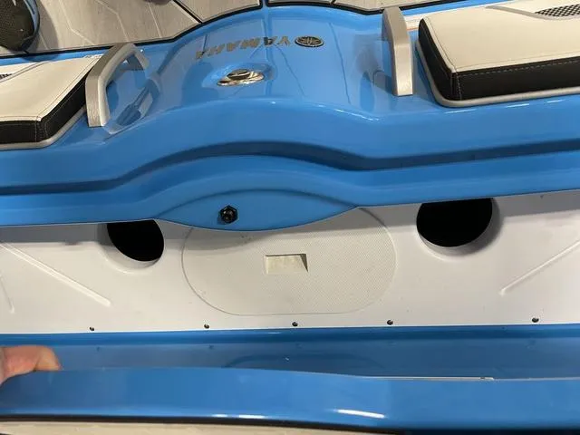Slide: The Image of 2023 Yamaha Boats 255XD, blue and white interior detail with seating and storage. - 43