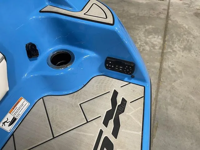 Slide: The Image of Close-up of 2023 Yamaha Boats 255XD blue deck with control panel. - 46