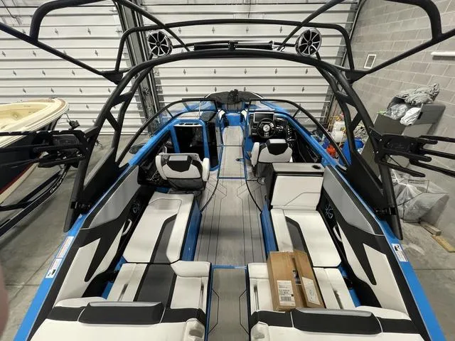 Slide: The Image of 2023 Yamaha Boats 255XD interior with sleek seating and modern design in a garage setting. - 6