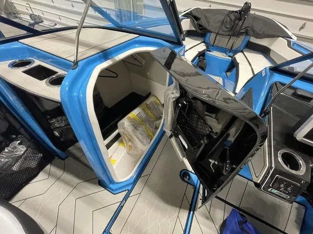 Slide: The Image of 2023 Yamaha Boats 255XD interior with storage compartments and seating. - 7