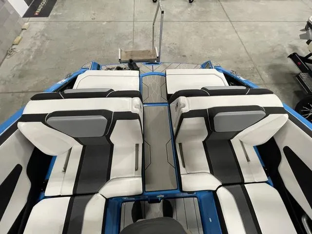 Slide: The Image of 2023 Yamaha Boats 255XD interior with sleek white and black seating design. - 8