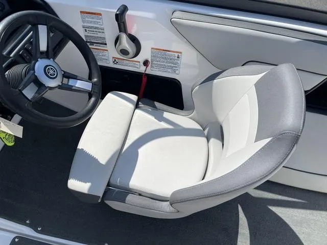 Slide: The Image of 2019 Yamaha Boats SX190 cockpit with steering wheel and cushioned seat. - 15