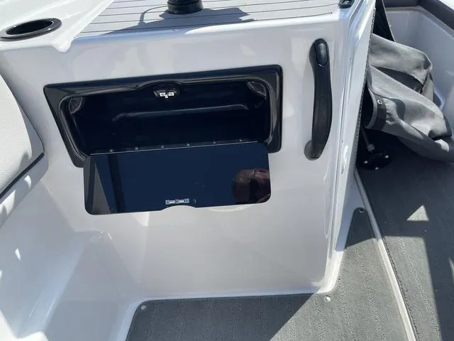 Slide: The Image of 2019 Yamaha SX190 boat interior with storage compartment and handle. - 16
