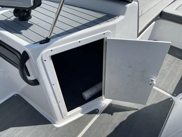 Slide: The Image of Open storage compartment on 2019 Yamaha SX190 boat deck. - 23