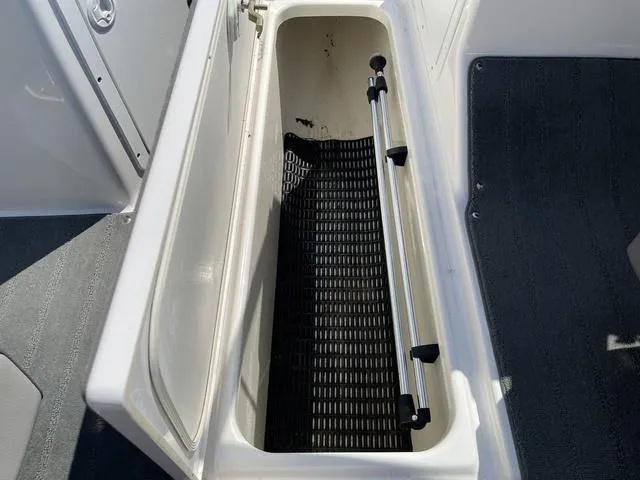 Slide: The Image of 2019 Yamaha SX190 boat storage compartment with open lid and interior view. - 26