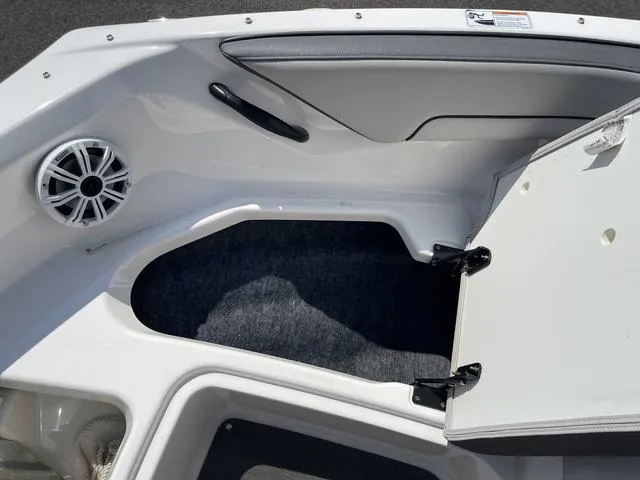 Slide: The Image of 2019 Yamaha SX190 boat interior storage compartment with speaker and open hatch. - 29