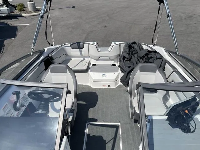 Slide: The Image of 2019 Yamaha Boats SX190 interior with seating and steering wheel, parked on pavement. - 32