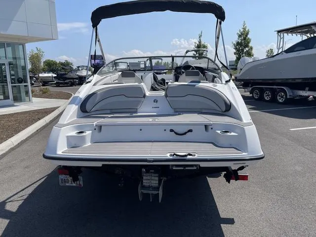 Slide: The Image of 2019 Yamaha Boats SX190, rear view, parked outdoors, showcasing sleek design and seating. - 6