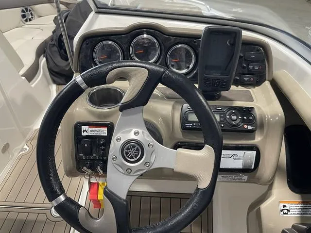 Slide: The Image of 2012 Yamaha Boats 242 Limited S cockpit with steering wheel and seating. - 16