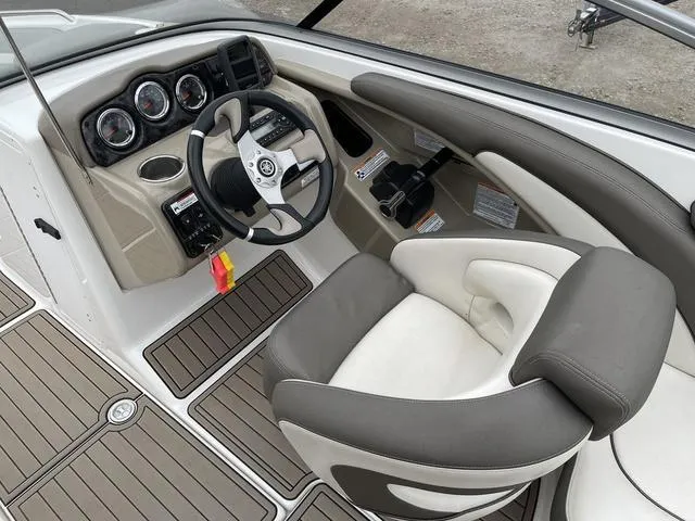 Slide: The Image of 2012 Yamaha Boats 242 Limited S interior with steering wheel and dashboard in a garage. - 17