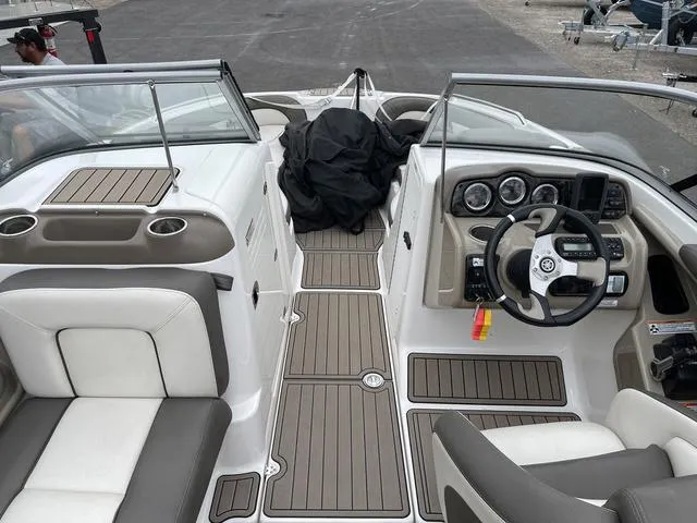 Slide: The Image of Interior of 2012 Yamaha Boats 242 Limited S, featuring cup holders and storage compartments. - 21