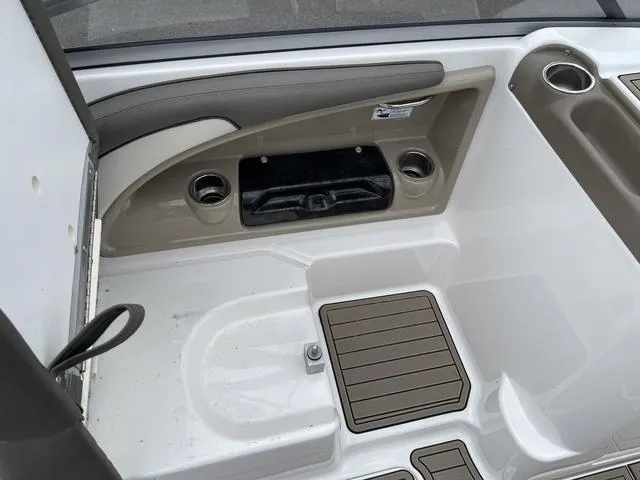 Slide: The Image of 2012 Yamaha Boats 242 Limited S interior storage compartment with visible wiring and seating. - 22