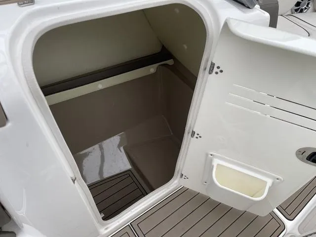 Slide: The Image of 2012 Yamaha Boats 242 Limited S interior with cushioned seating and teak-style flooring. - 26