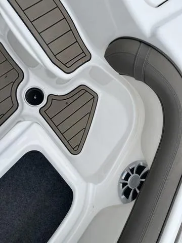 Slide: The Image of 2012 Yamaha Boats 242 Limited S bow seating area with cushioned seats and deck hatch. - 30