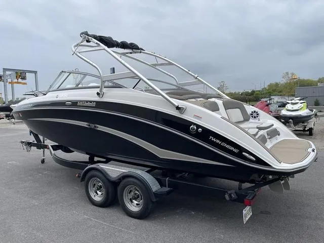 Slide: The Image of 2012 Yamaha Boats 242 Limited S on trailer, sleek black and white design. - 6