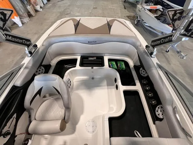 Slide: The Image of 2010 MasterCraft X-Star boat interior with seating and storage compartments. - 10