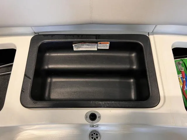 Slide: The Image of 2010 MasterCraft X-Star storage compartment with black interior and white exterior. - 13