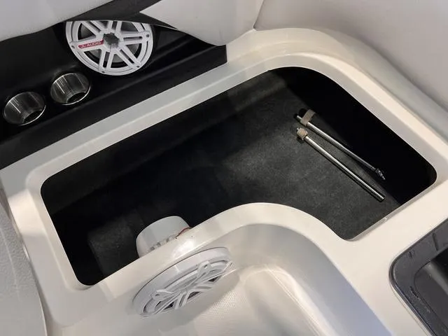 Slide: The Image of 2010 MasterCraft X-Star boat storage compartment with speakers and cup holders. - 14