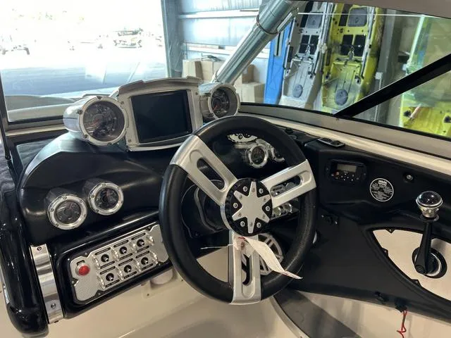 Slide: The Image of 2010 MasterCraft X-Star boat dashboard with steering wheel and gauges. - 16