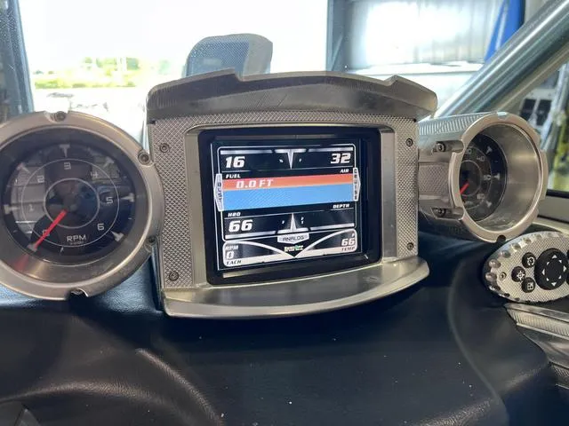 Slide: The Image of Dashboard of a 2010 MasterCraft X-Star boat with digital display and gauges. - 18