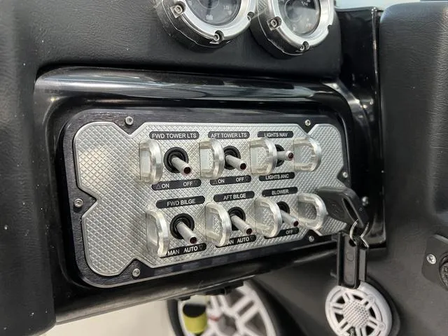 Slide: The Image of Control panel of a 2010 MasterCraft X-Star boat with switches and gauges. - 20