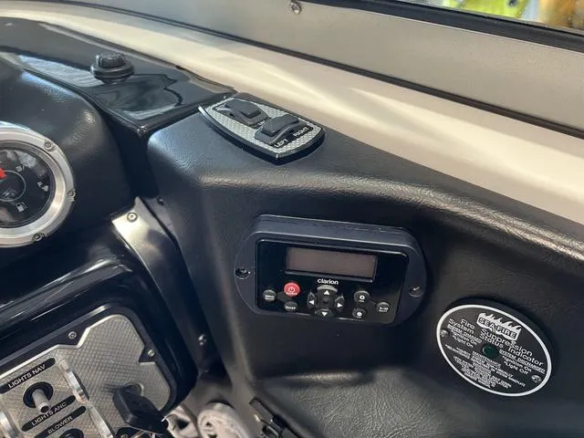 Slide: The Image of Dashboard of 2010 MasterCraft X-Star boat with Clarion audio system controls. - 22