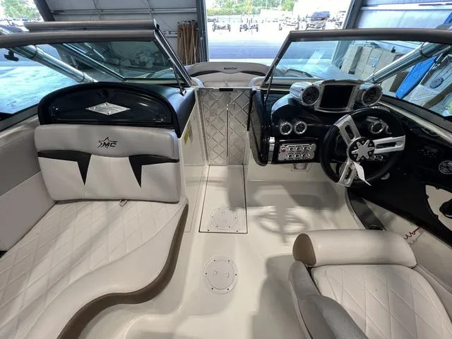 Slide: The Image of 2010 MasterCraft X-Star boat interior with sleek seating and modern dashboard. - 23