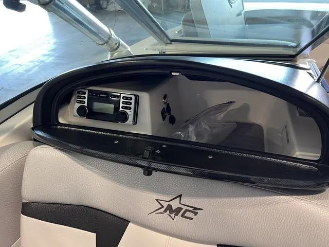 Slide: The Image of 2010 MasterCraft X-Star dashboard with stereo system and MC logo. - 24